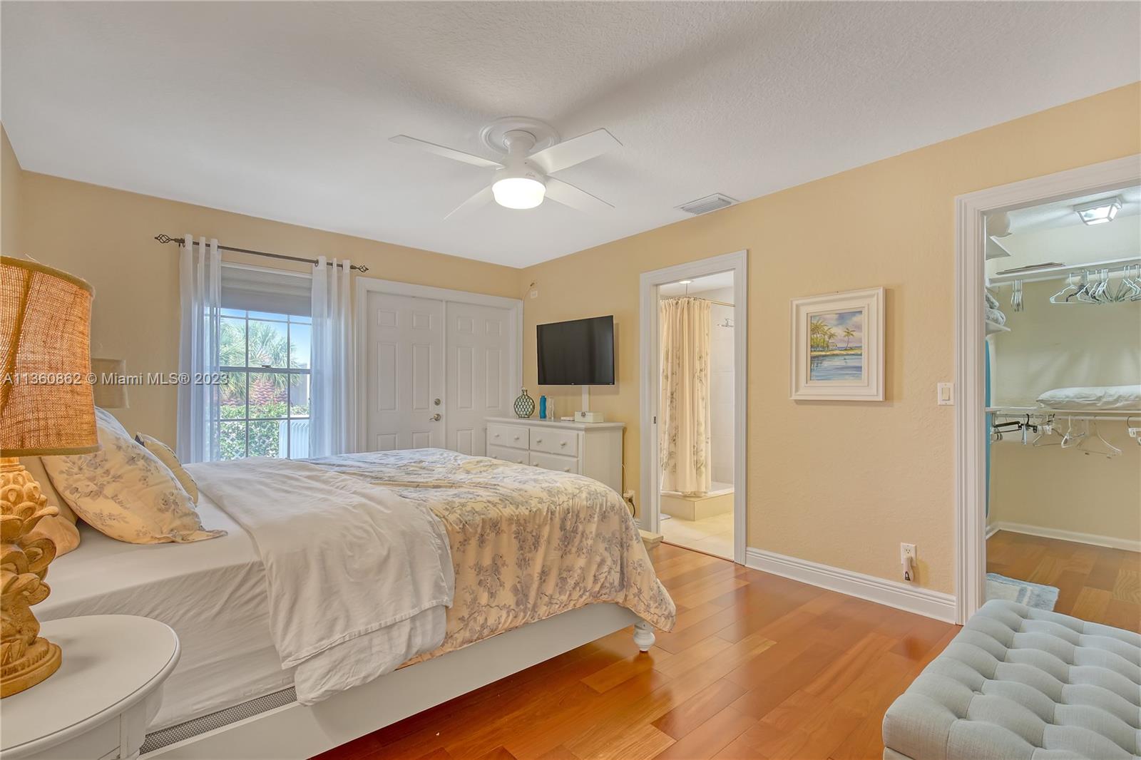 119 Ocean Dunes Circle Jupiter, FL 33477 - Photo 26 of 39 a bedroom with a large bed and a window