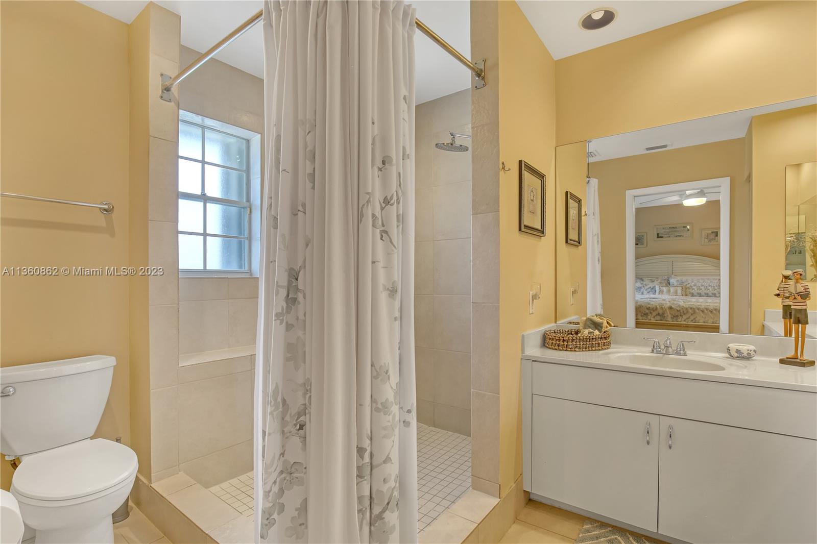 119 Ocean Dunes Circle Jupiter, FL 33477 - Photo 31 of 39 a bathroom with a toilet sink and shower