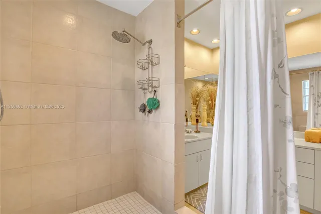 a bathroom that has a glass shower door