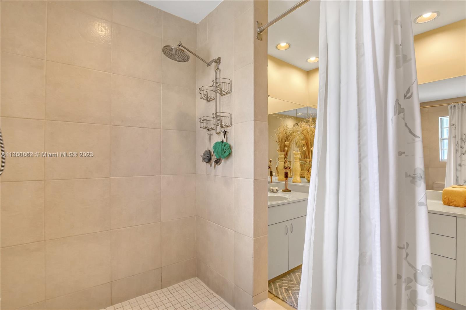 119 Ocean Dunes Circle Jupiter, FL 33477 - Photo 32 of 39 a bathroom that has a glass shower door