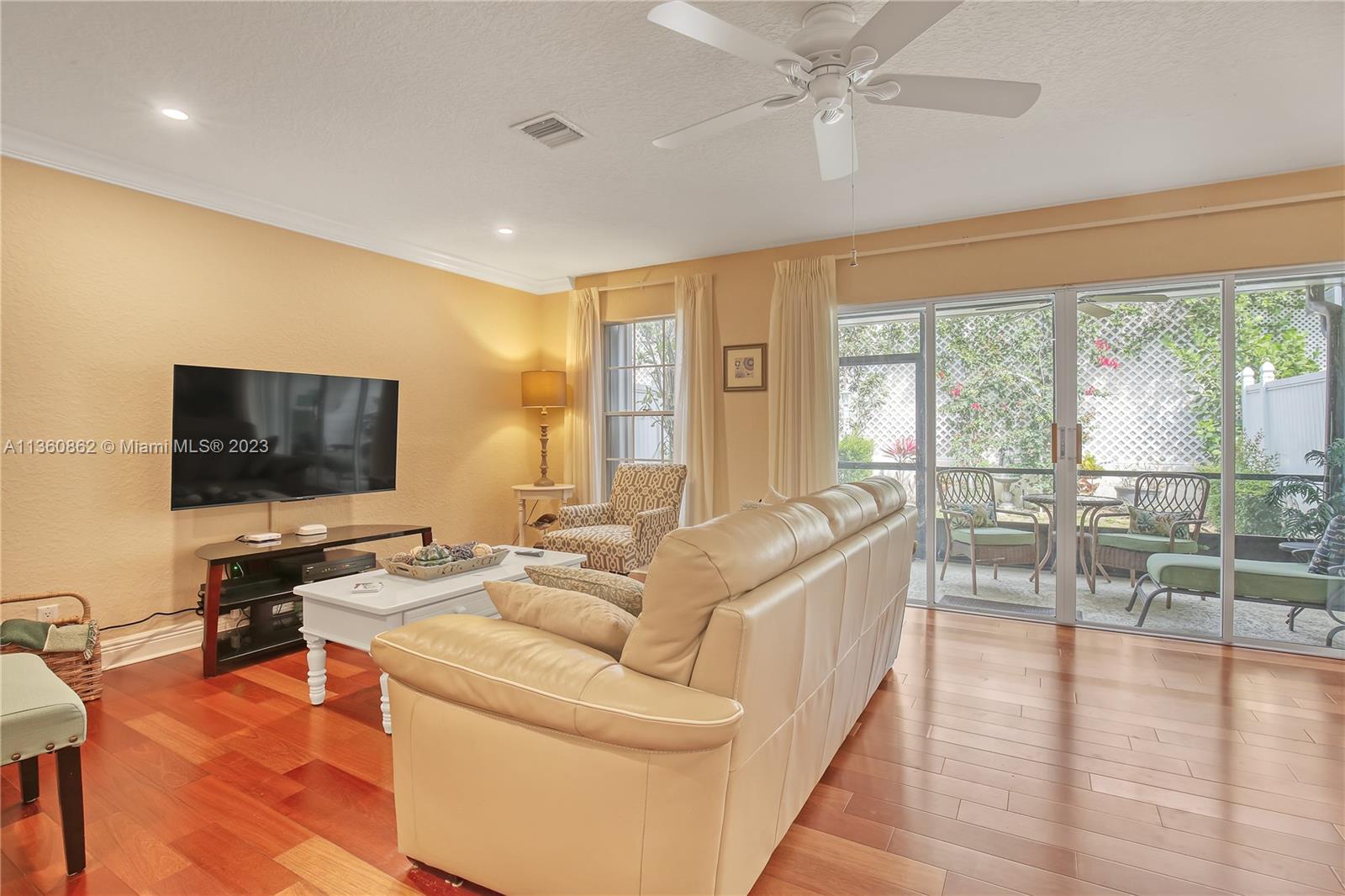 119 Ocean Dunes Circle Jupiter, FL 33477 - Photo 7 of 39 a living room with furniture and a flat screen tv