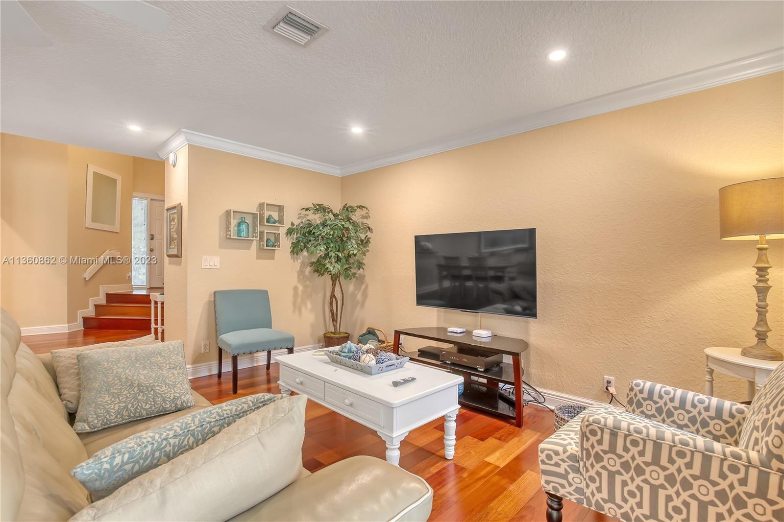 119 Ocean Dunes Circle Jupiter, FL 33477 - Photo 9 of 39 a living room with furniture and a flat screen tv