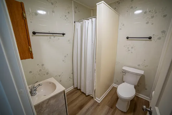a bathroom with a toilet and a shower