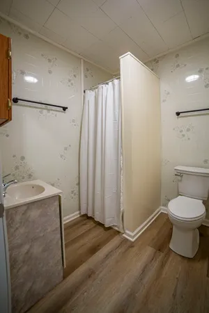 a bathroom with a sink toilet and shower