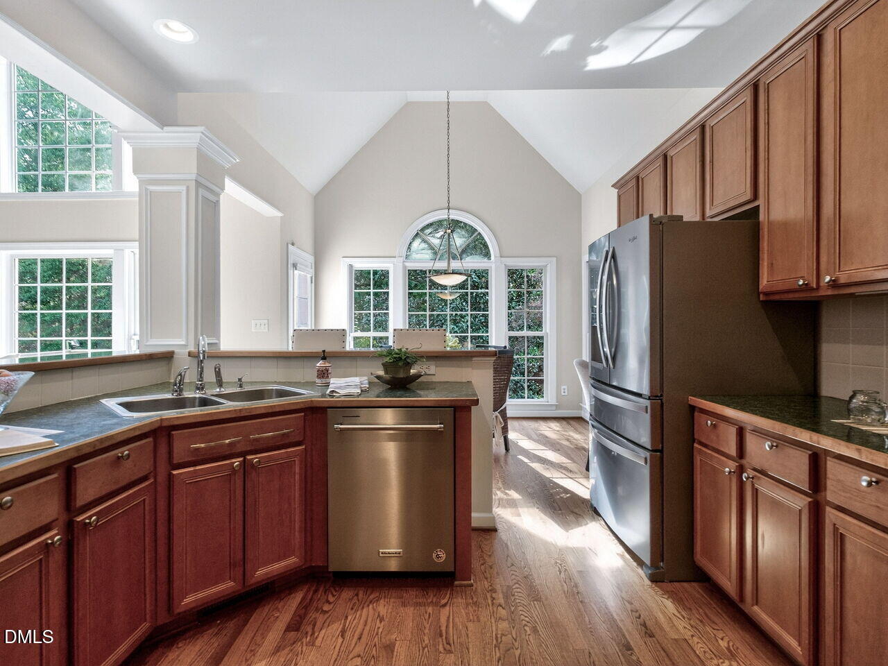 6232 Big Sandy Drive Raleigh, NC 27616 - Photo 18 of 39 a kitchen with stainless steel appliances granite countertop a refrigerator a sink dishwasher a stove and white countertops with wooden floor