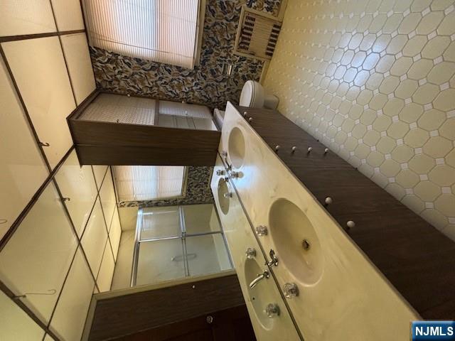 15 Albion Street Passaic, NJ 07055 - Photo 15 of 23 a bathroom with a double vanity sink and mirror