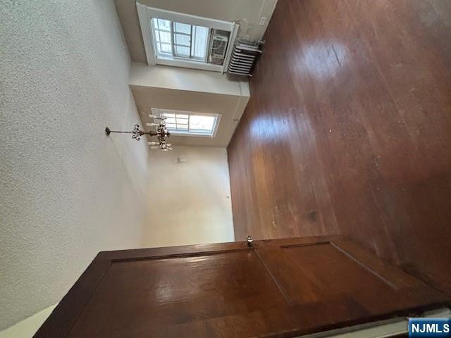 15 Albion Street Passaic, NJ 07055 - Photo 16 of 23 an empty room with staircase and windows