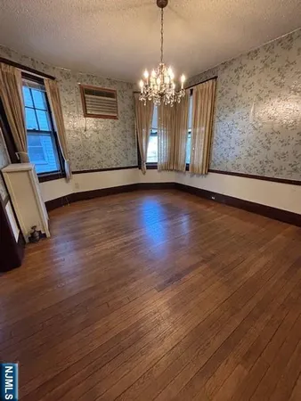 a view of a livingroom with wooden floor and a ceiling fan
