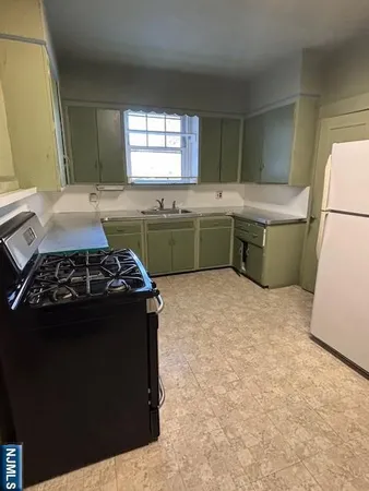 a kitchen with a stove and a refrigerator
