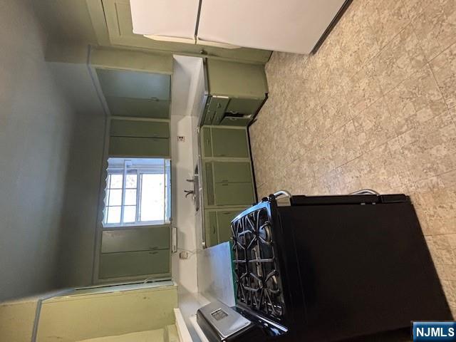 15 Albion Street Passaic, NJ 07055 - Photo 6 of 23 a kitchen with a stove and a refrigerator