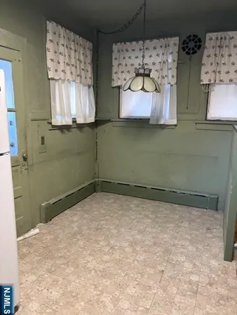 view of a room with wooden floor and windows