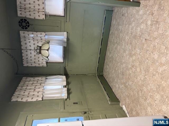 15 Albion Street Passaic, NJ 07055 - Photo 8 of 23 view of a room with wooden floor and windows