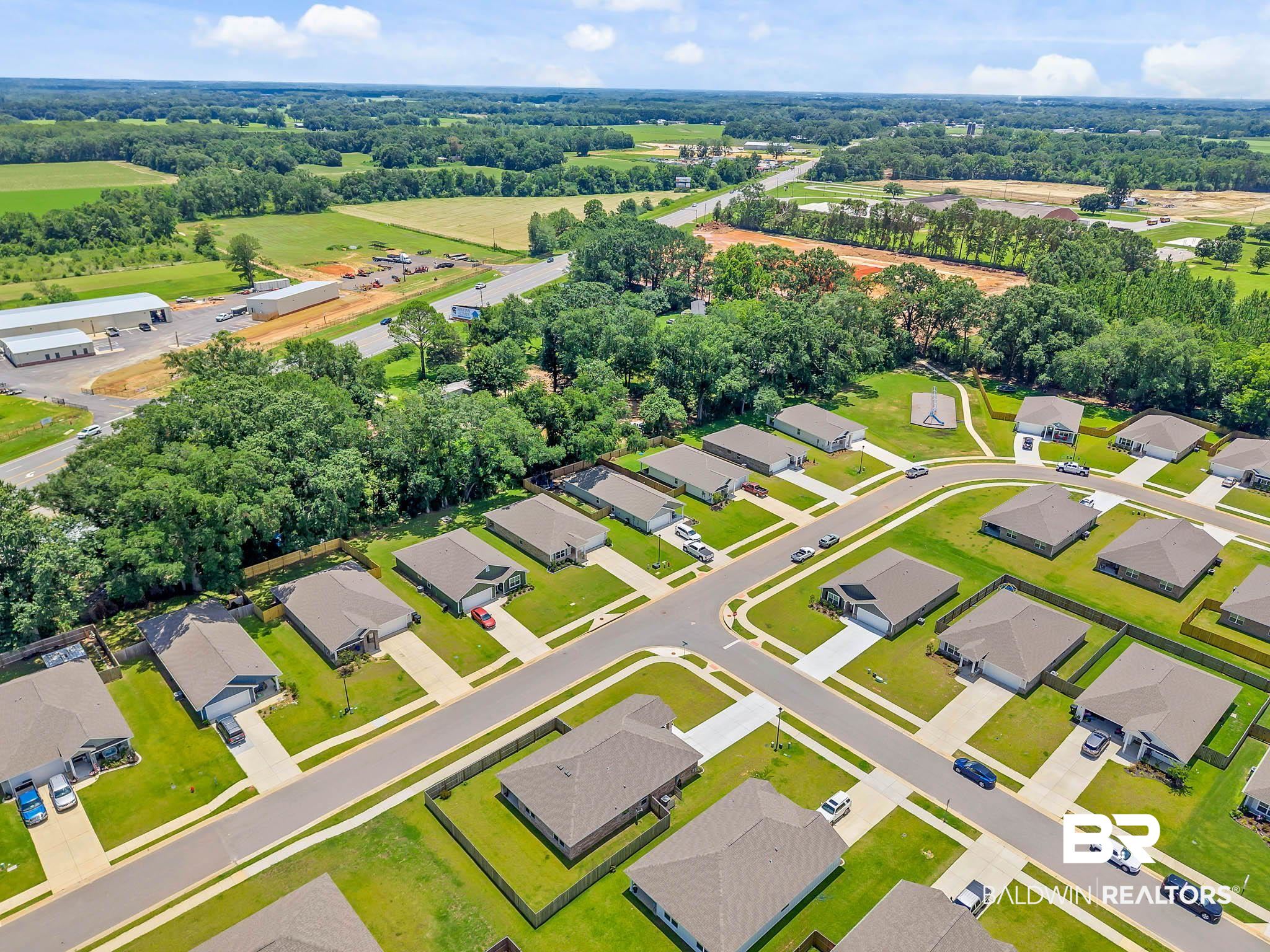 17217 REFLECTION Street Loxley, AL 36551 - Photo 77 of 83 Aerial perspective of suburban area with a tree filled landscape