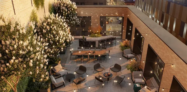 a view of a patio with a table and chairs