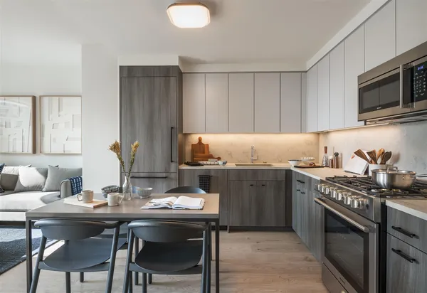a kitchen with granite countertop a sink and a stove top oven with wooden floor