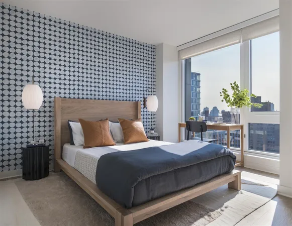 a bedroom with a bed lamp and window