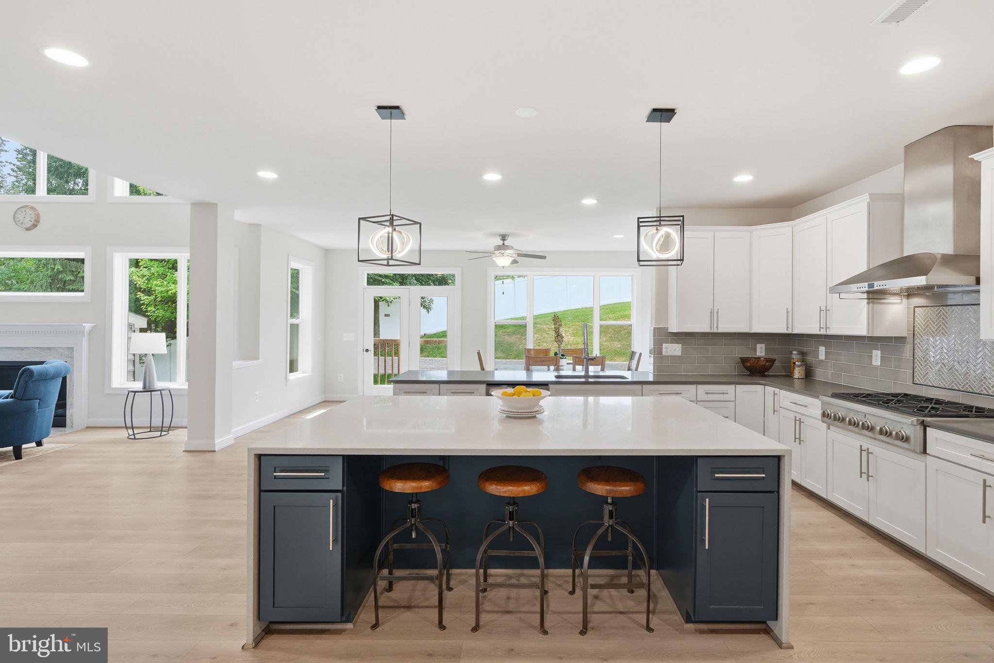 7821 Old Falls Road McLean, VA 22102 - Photo 18 of 62 a large kitchen with granite countertop a stove a sink a table and chairs