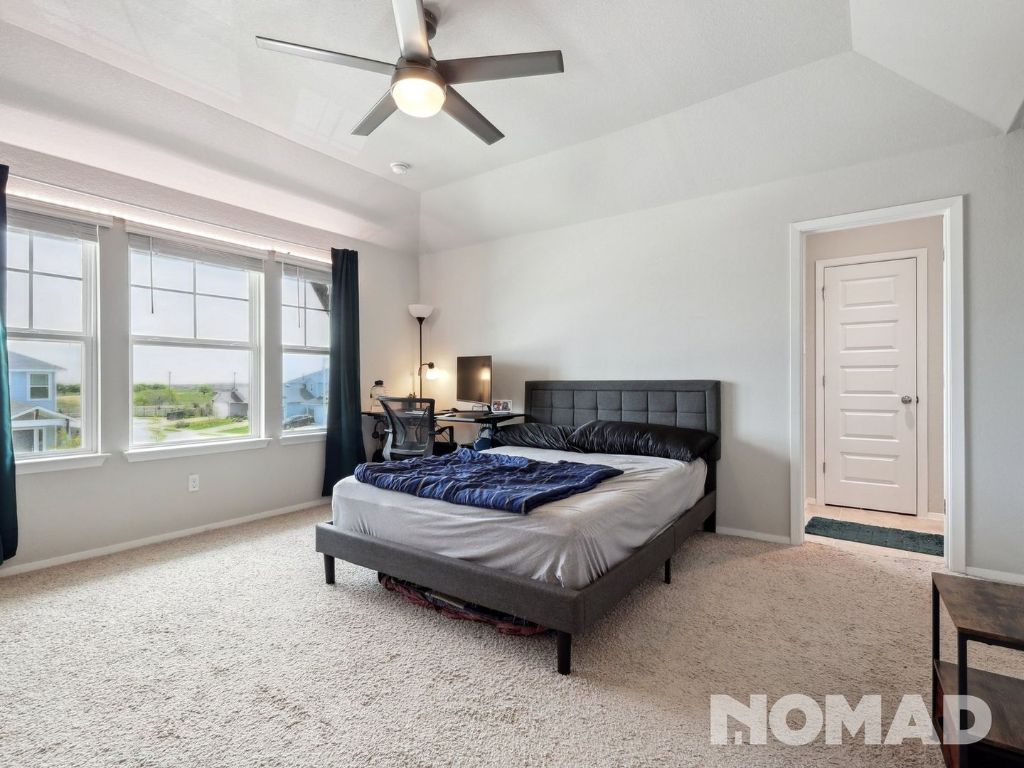 101 Crescent Street Georgetown, TX 78626 - Photo 12 of 28 a spacious bedroom with a bed a window and walk in closet