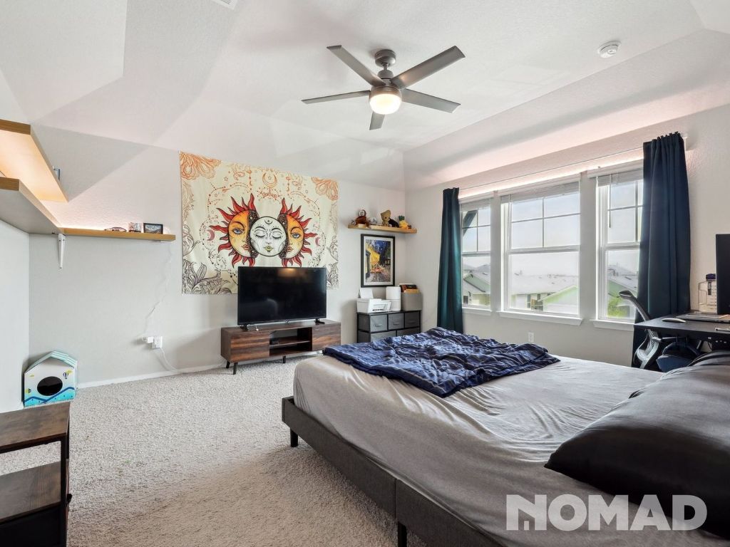 101 Crescent Street Georgetown, TX 78626 - Photo 14 of 28 a bedroom with a bed and a flat screen tv