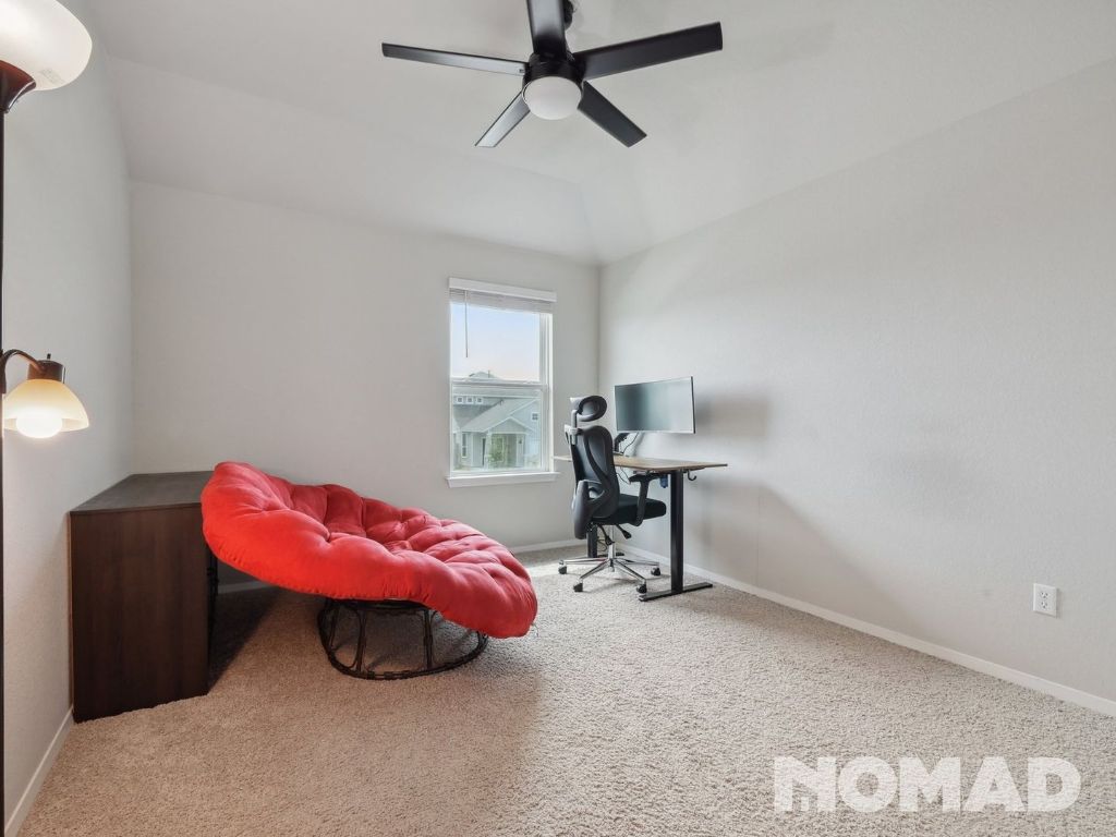 101 Crescent Street Georgetown, TX 78626 - Photo 20 of 28 a bedroom with a bed and a chair