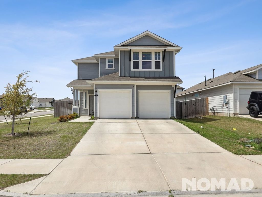 101 Crescent Street Georgetown, TX 78626 - Photo 21 of 28 a front view of a house with a yard and garage