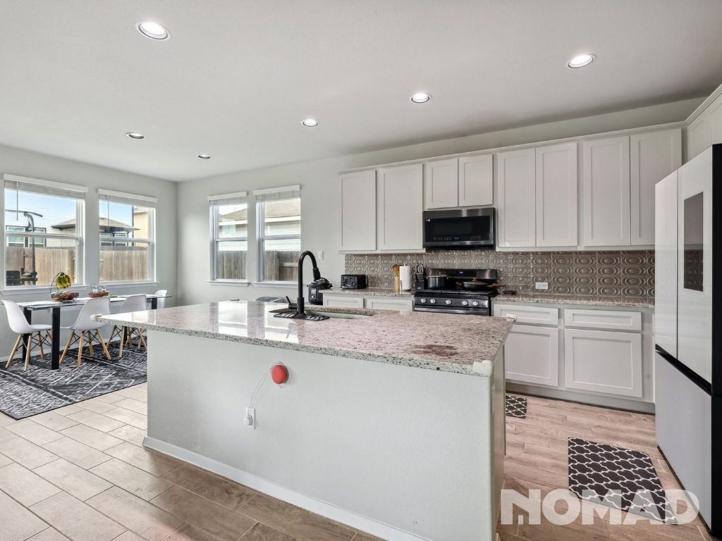 101 Crescent Street Georgetown, TX 78626 - Photo 7 of 28 a kitchen with sink a microwave and cabinets