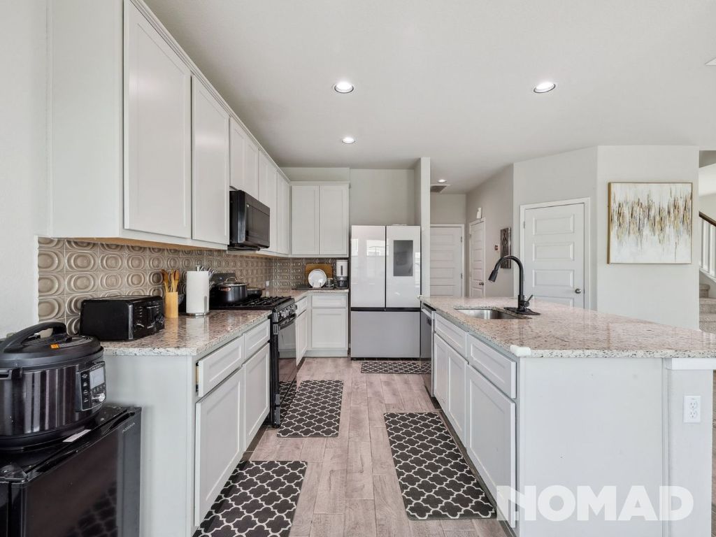 101 Crescent Street Georgetown, TX 78626 - Photo 9 of 28 a kitchen with a sink stove and cabinets