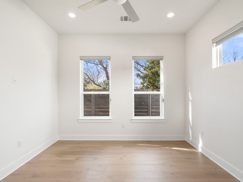 709 West St Elmo Road, Unit 2 Austin, TX 78745 - Photo 13 of 26 Unfurnished room with light wood finished floors, ceiling fan, and recessed lighting