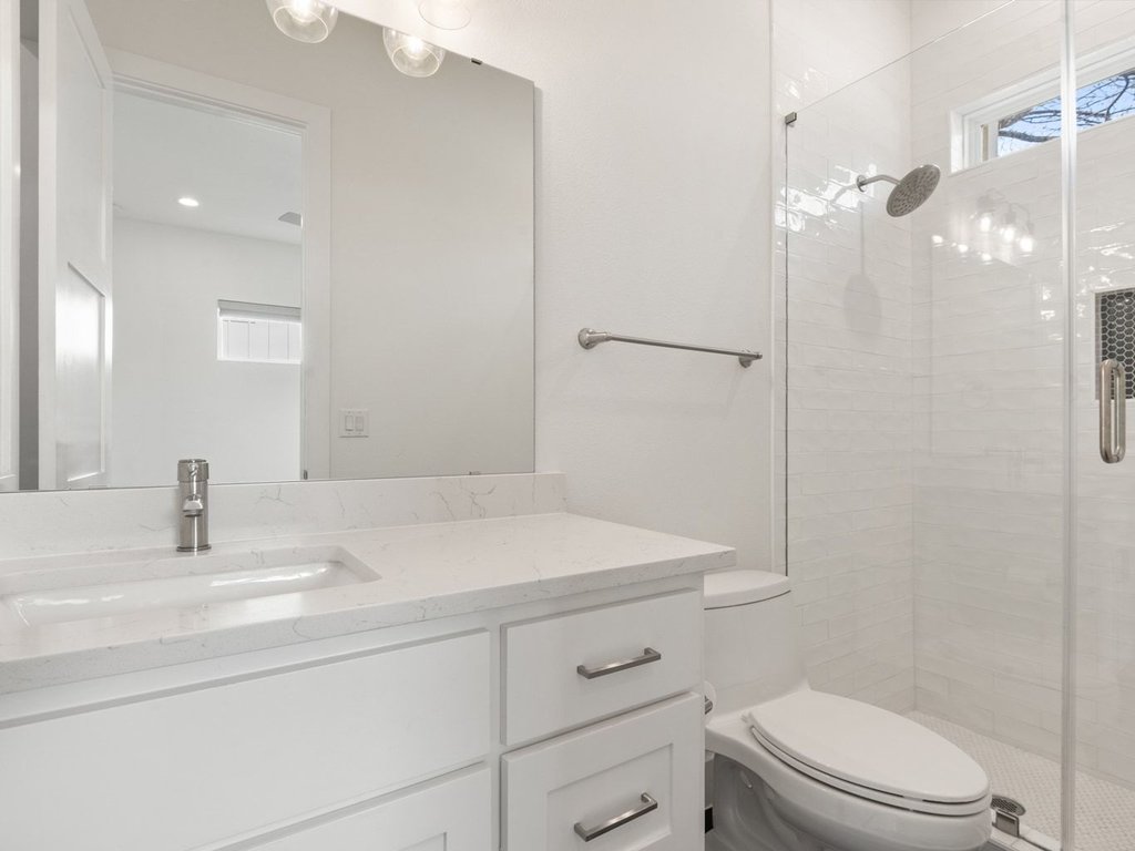 709 West St Elmo Road, Unit 2 Austin, TX 78745 - Photo 15 of 26 Bathroom featuring a stall shower and vanity