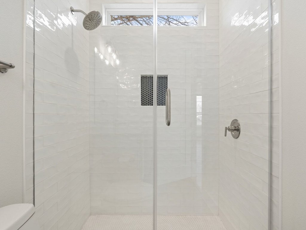 709 West St Elmo Road, Unit 2 Austin, TX 78745 - Photo 16 of 26 Bathroom featuring a shower stall and toilet