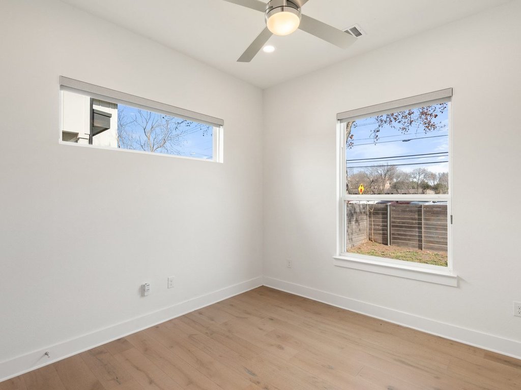 709 West St Elmo Road, Unit 2 Austin, TX 78745 - Photo 18 of 26 Empty room featuring light wood-type flooring, ceiling fan, and recessed lighting