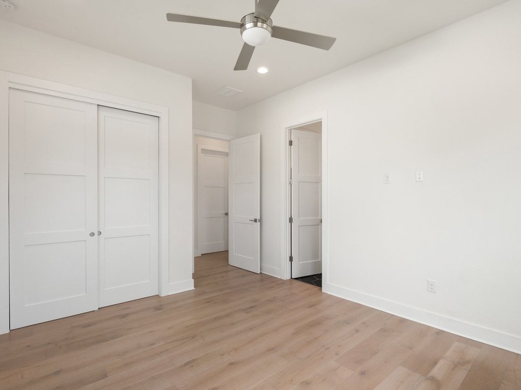 709 West St Elmo Road, Unit 2 Austin, TX 78745 - Photo 19 of 26 Unfurnished bedroom featuring wood finished floors, a ceiling fan, a closet, and recessed lighting