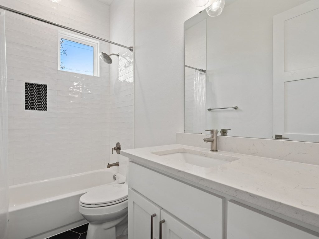 709 West St Elmo Road, Unit 2 Austin, TX 78745 - Photo 20 of 26 Bathroom featuring shower / bath combination, vanity, and dark tile patterned flooring