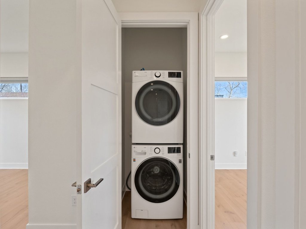 709 West St Elmo Road, Unit 2 Austin, TX 78745 - Photo 21 of 26 Laundry area featuring stacked washer / dryer and light wood-style floors