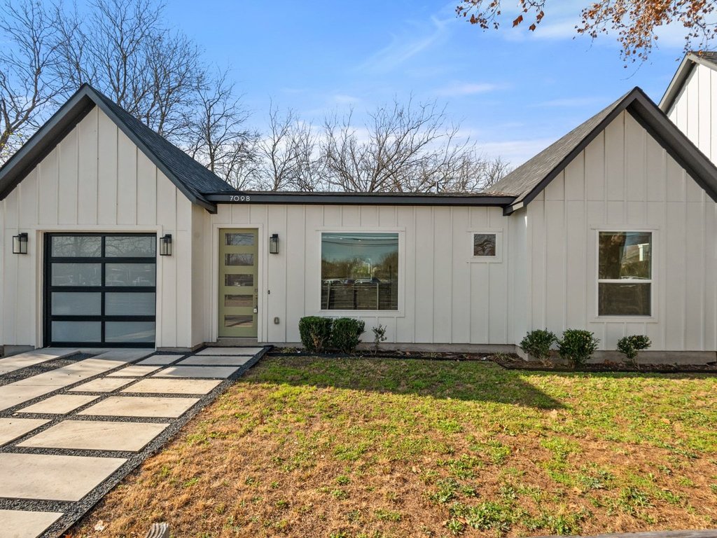 709 West St Elmo Road, Unit 2 Austin, TX 78745 - Photo 5 of 26 Modern inspired farmhouse with board and batten siding, a front yard, a garage, and driveway