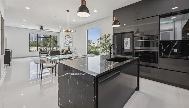 a kitchen with granite countertop a stove and cabinets