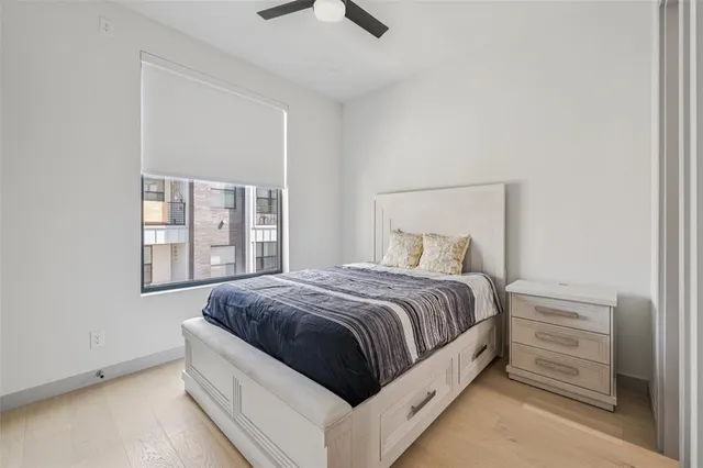 a spacious bedroom with a bed and a window