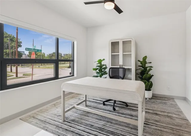a dining room with furniture window and wooden floor