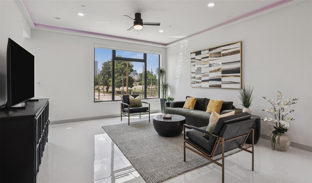 1874 Beaumont Street Dallas, TX 75215 - Photo 10 of 38 a living room with furniture a large window and a flat screen tv