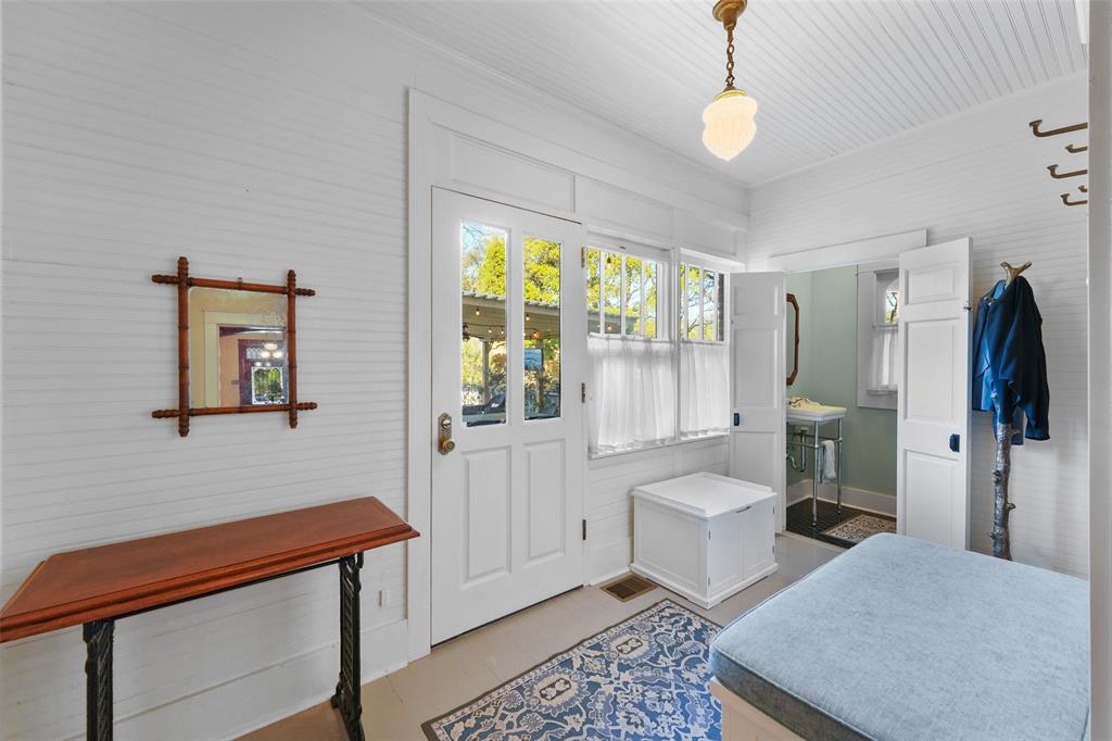406 Griffith Avenue Terrell, TX 75160 - Photo 26 of 40 Entryway featuring a white paneled door with glass inserts, a single-paned window with white curtains, and a ceiling-mounted light fixture