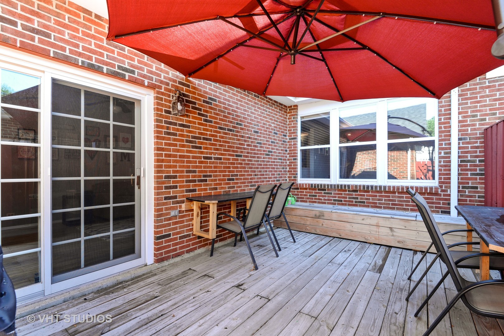 9054 Forestview Road Evanston, IL 60203 - Photo 12 of 24 a view of a roof deck with table and chairs under an umbrella