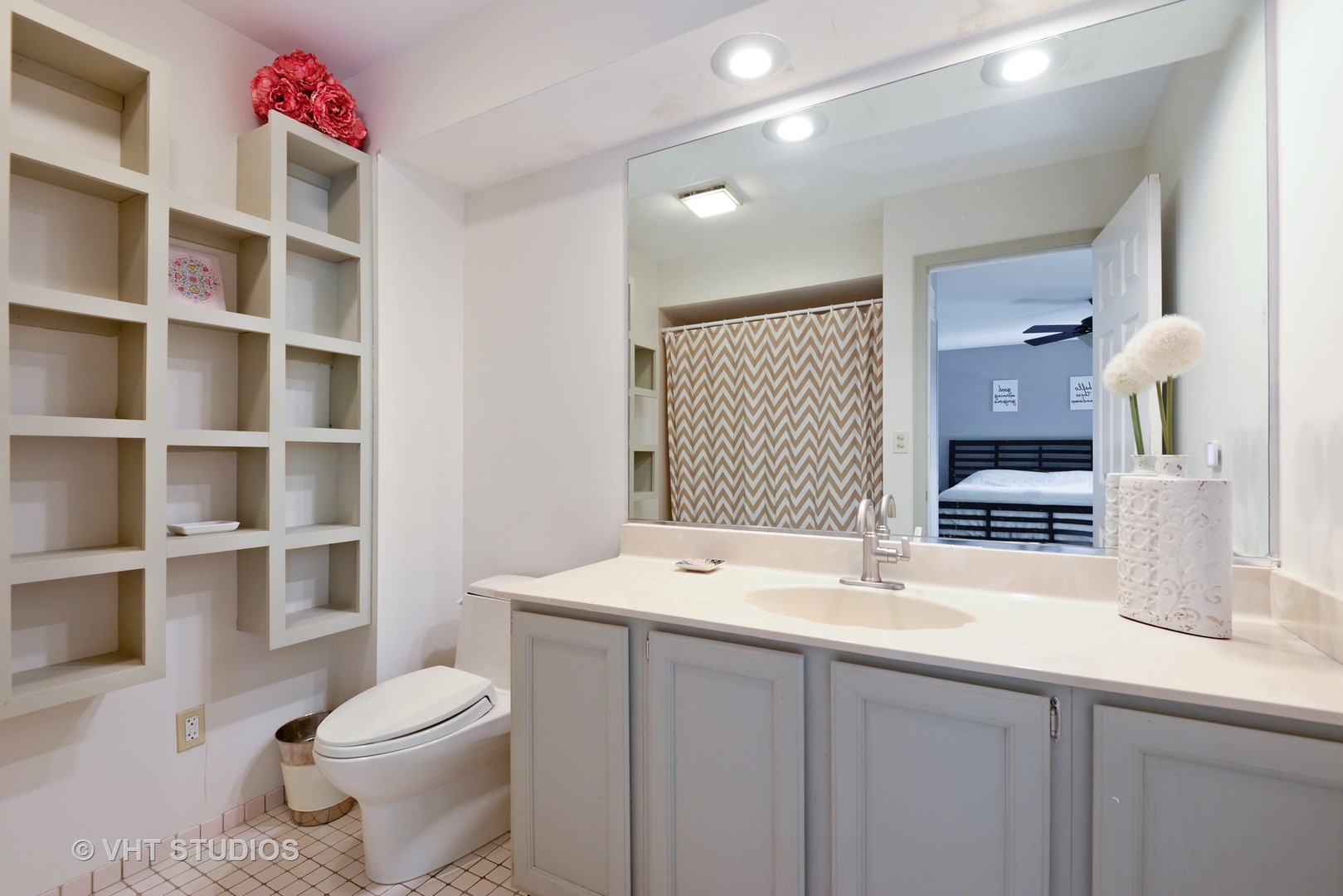 9054 Forestview Road Evanston, IL 60203 - Photo 13 of 24 a bathroom with a sink a toilet and a mirror