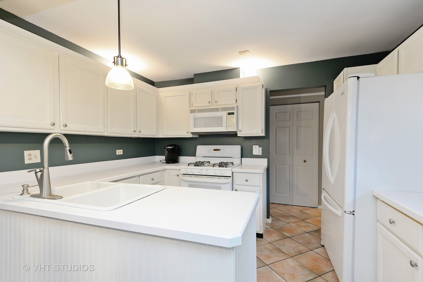 9054 Forestview Road Evanston, IL 60203 - Photo 4 of 24 a kitchen with a sink a refrigerator and cabinets