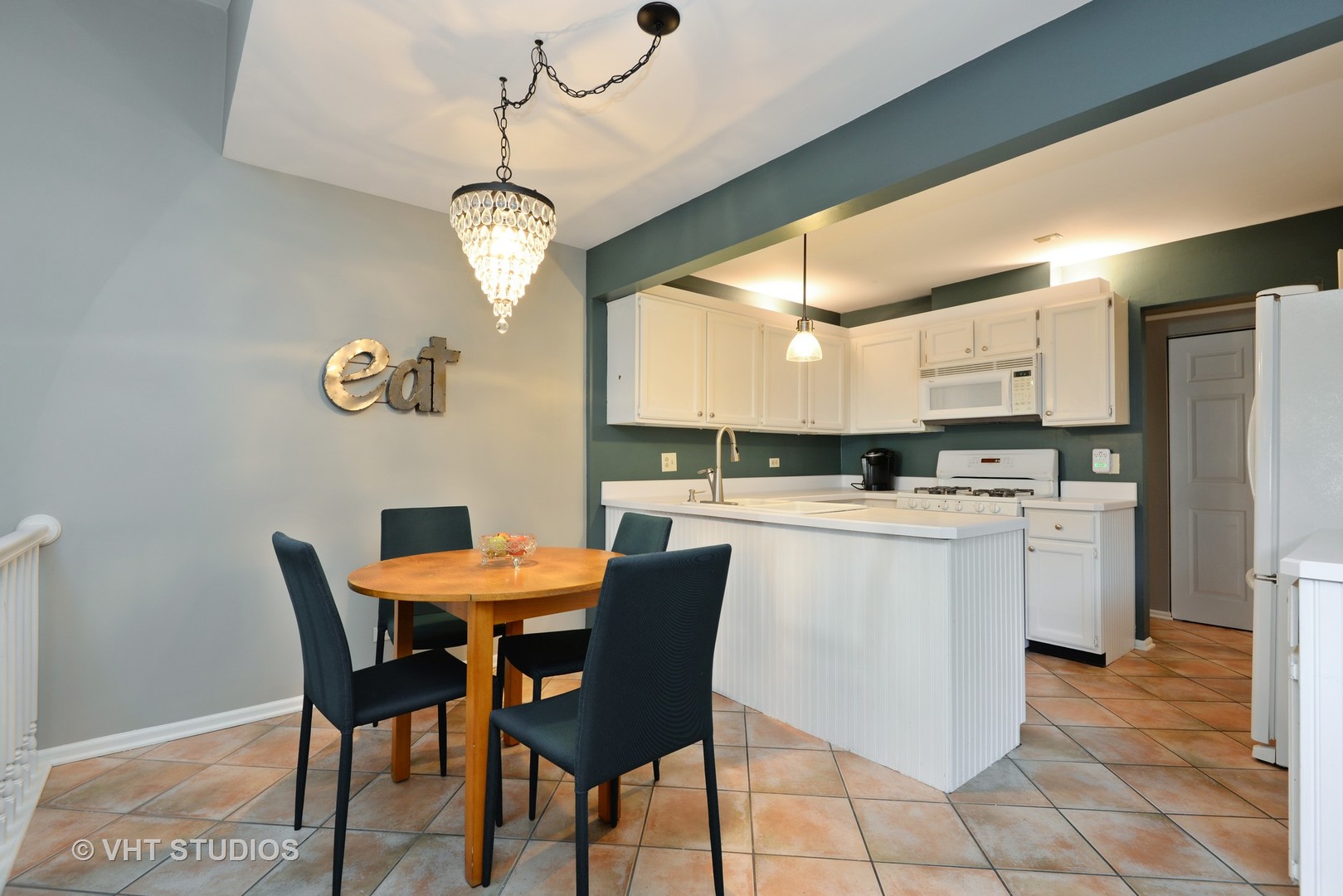 9054 Forestview Road Evanston, IL 60203 - Photo 6 of 24 a kitchen with a dining table chairs and refrigerator