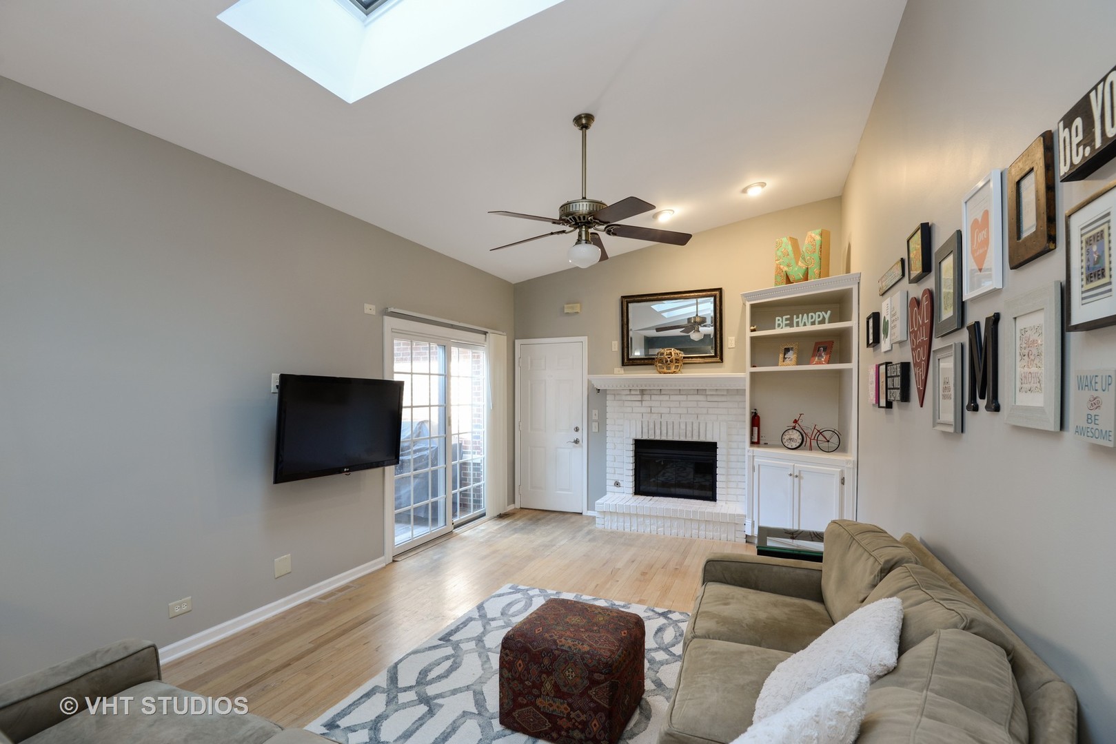 9054 Forestview Road Evanston, IL 60203 - Photo 9 of 24 a living room with furniture a fireplace and a flat screen tv