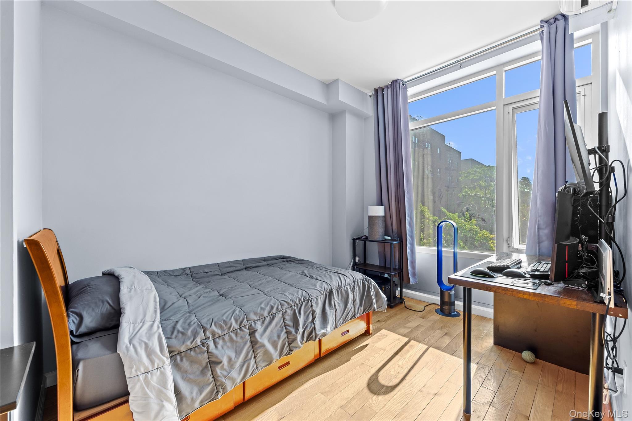 95-08 65th Road, Unit 3C Queens, NY 11374 - Photo 11 of 19 Bedroom with light wood-style floors and baseboards