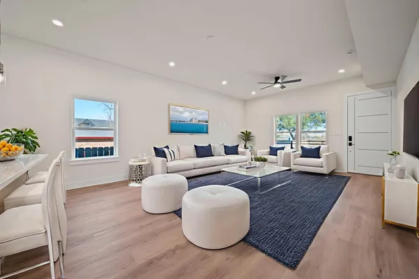 a large kitchen with a large counter top a sink stainless steel appliances and cabinets