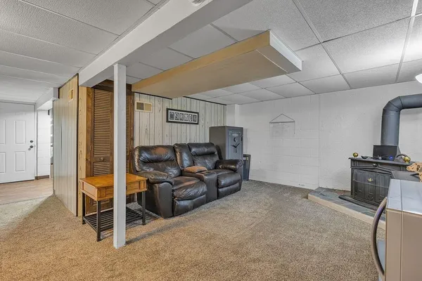 a living room with furniture gym equipment and a fireplace