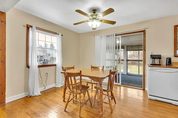 a view of a dining room with furniture window and wooden floor