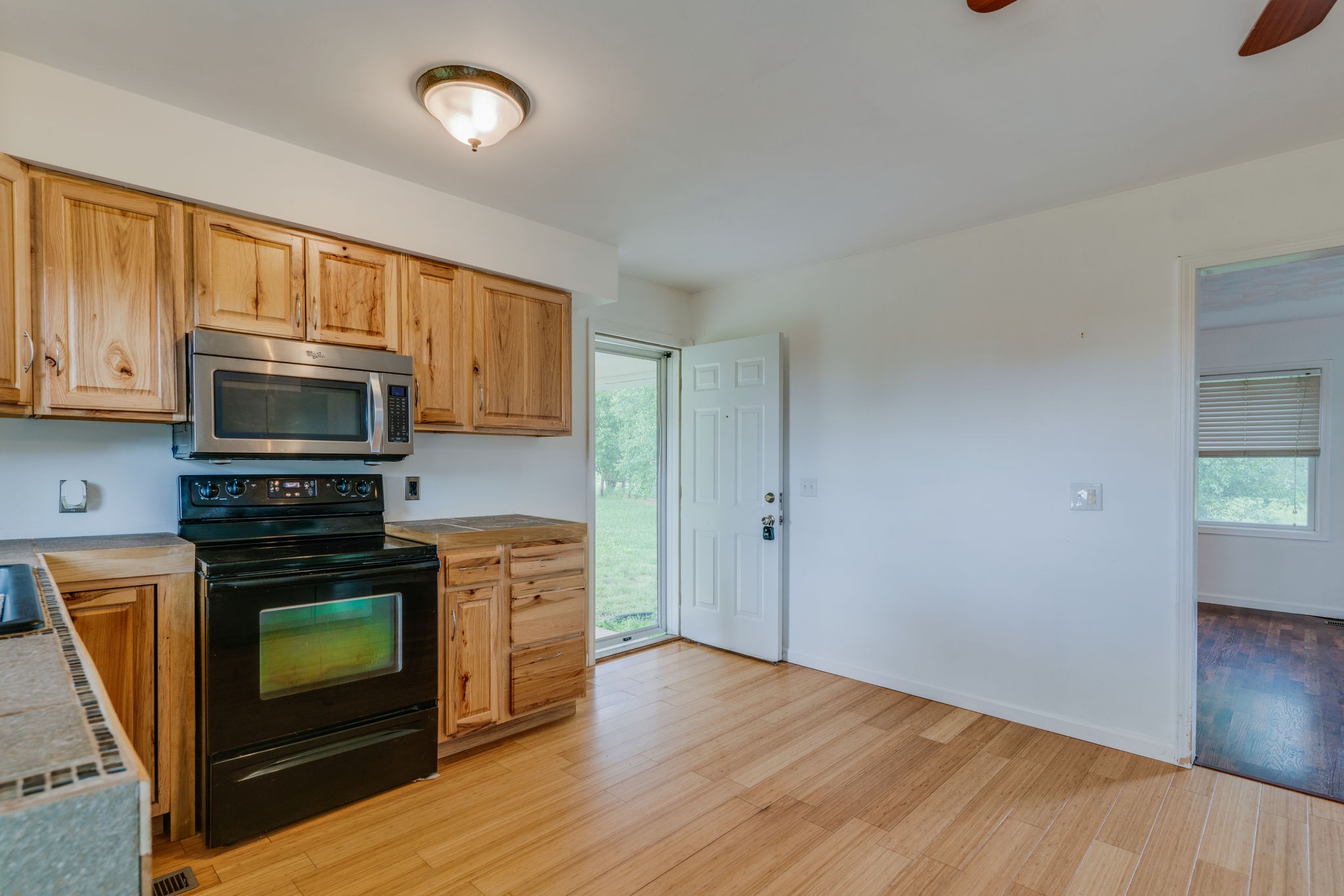 4614 Woodrow Wilson Road Springfield, TN 37172 - Photo 11 of 29 a kitchen with granite countertop wooden floors a stove and a refrigerator